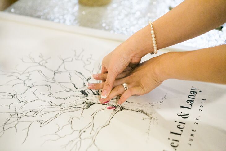 Instead of a traditional guest book, LeiLei and Lanay wanted something they could easily display in their home and appreciate regularly. They opted for an illustration of a tree, which they had their guests decorate with their fingerprints in a palette of colorful hues