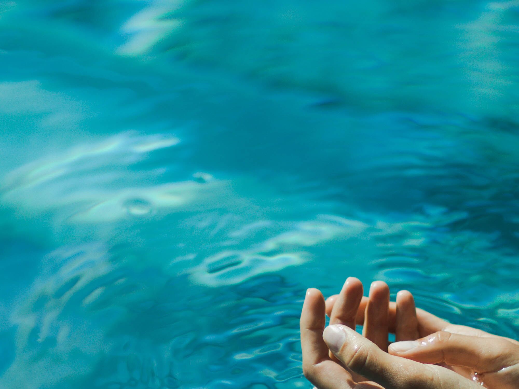 Hands in water, suggesting a relaxing sunny day