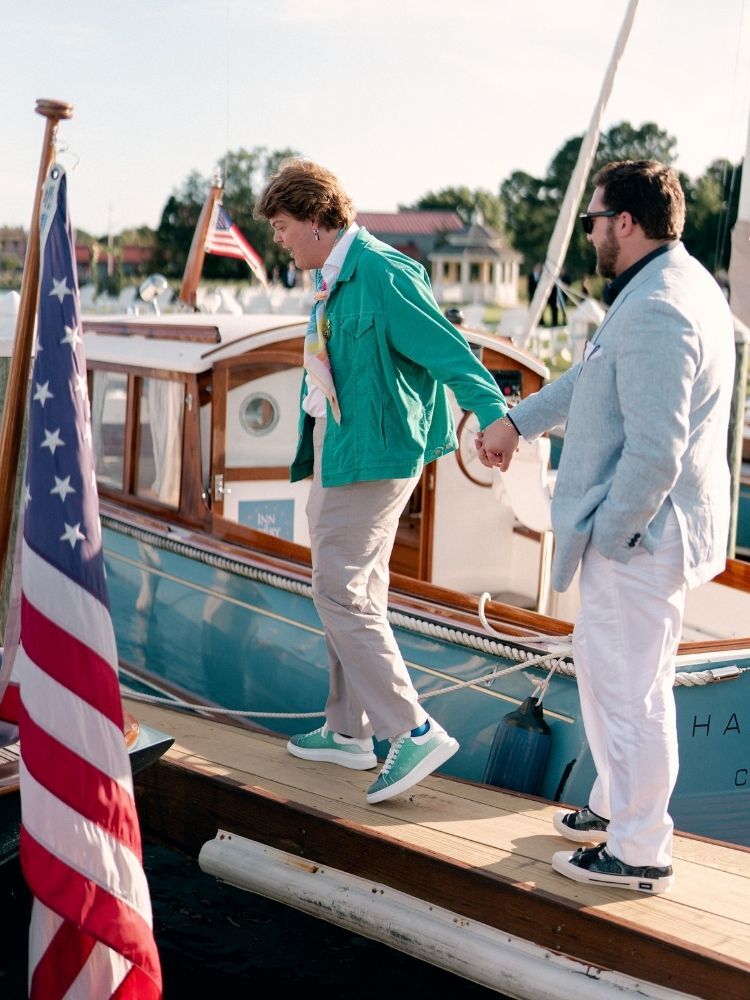 couple walking on boat dock during engagement photo shoot