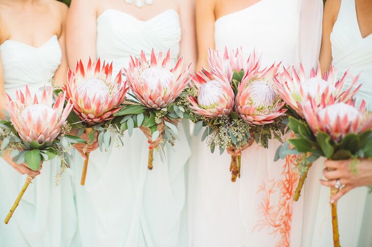 For their bouquets, Whitney and her bridesmaids each carried a single King Protea down the aisle. “They were simple, but had huge wow-factor,” says Whitney. “The color paired perfectly with the coral on my dress.”rn