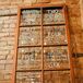 The bride and groom painted their guest's seating assignments on a repurposed window.