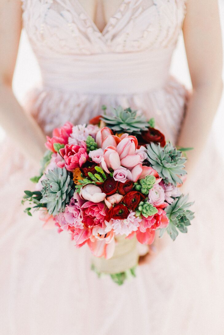The florals were completely dependent on whatever was local and available. Luckily, Danielle’s bouquet turned out completely gorgeous and fitting for the beachy theme: It had succulents blended with bright red ranunculus, blush tulips, roses and peonies.