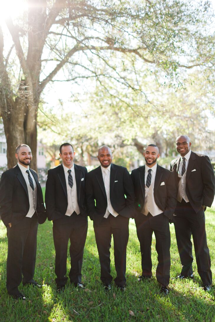After a trip to Men's Wearhouse, Josh and his groomsmen were ready for the outdoor wedding with a formal look. Each man wore a dapper black tuxedo, white shirt, striped black tie and a champagne vest for an unexpected hint of color. In lieu of a boutonniere, they simply accessorized with white pocket squares.