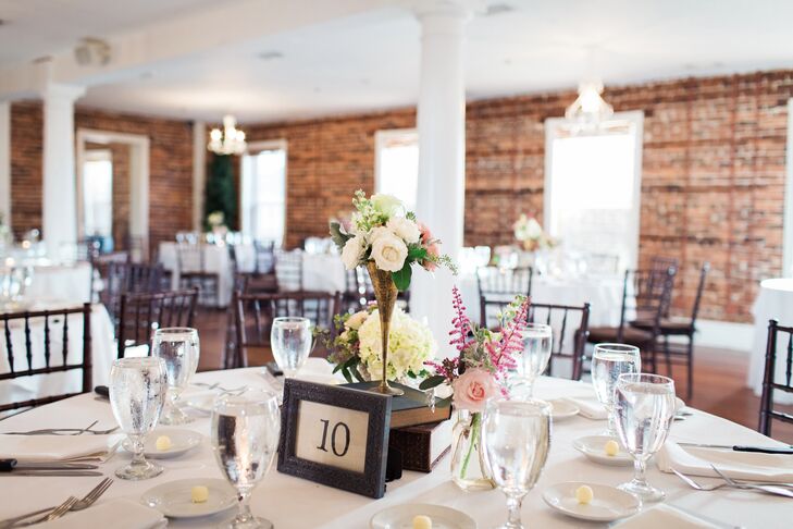 Wanting to highlight The White Room's exposed brick walls and vintage furniture, the couple decorated their reception with simple white linens, black chiavari chairs and unique vintage-inspired centerpieces designed by their florist,  Jade Violet Wedding and Event Floral Boutique.