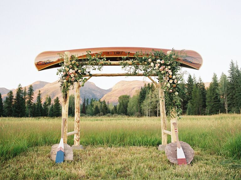 rustic wedding arch alternative made from canoe and tree branch poles
