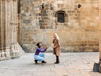 Woman proposing to her fiancée outside