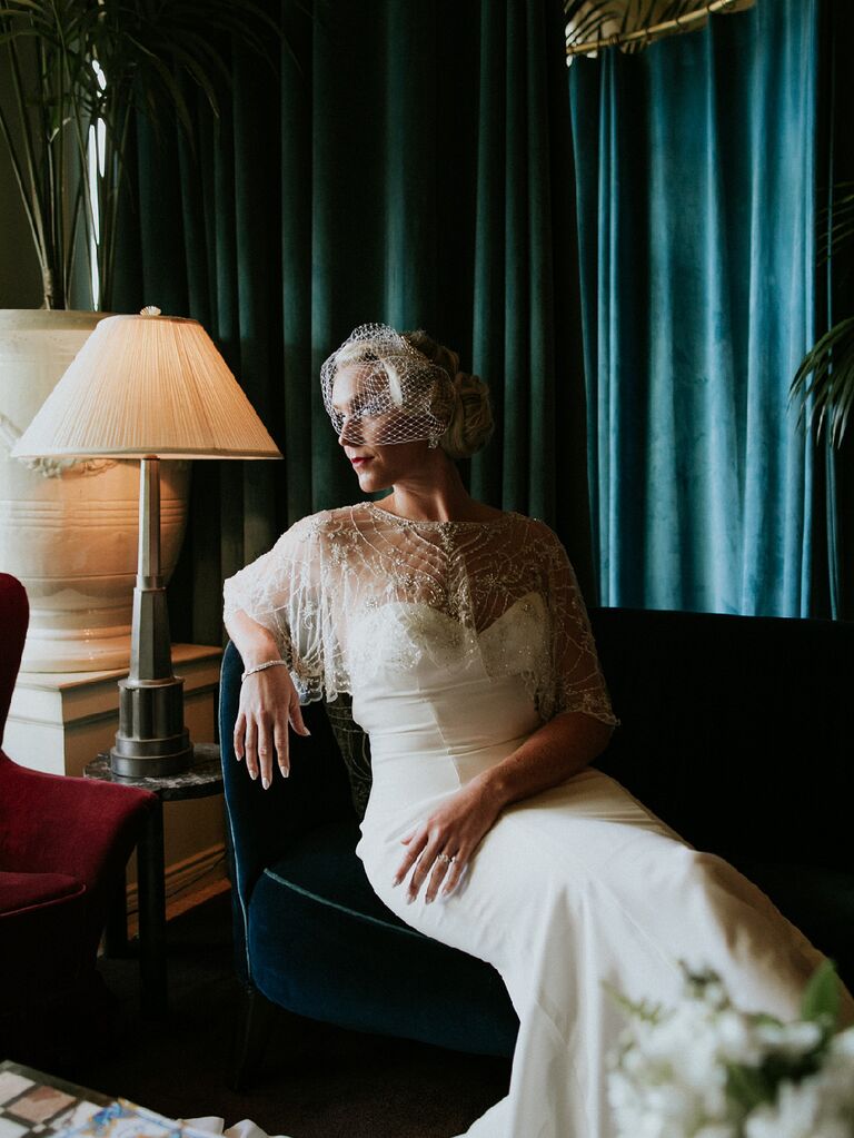 1920s-inspired bride with beaded cape and vintage bird cage veil