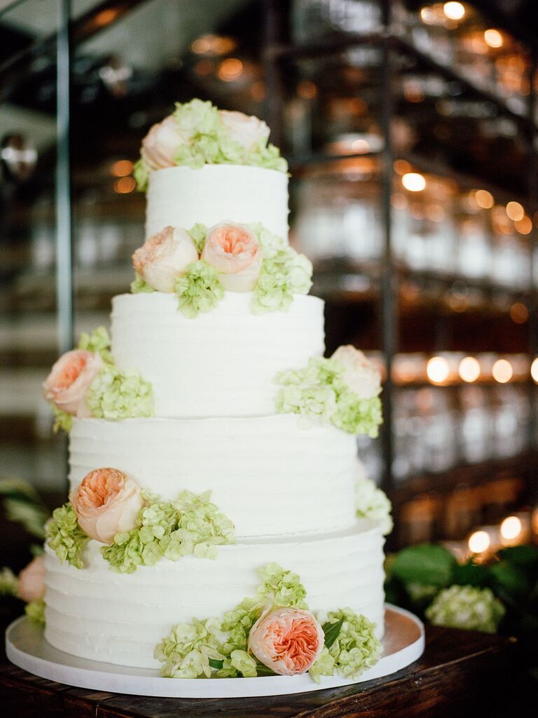 four tier textured buttercream cake with blush garden roses and green hydrangeas