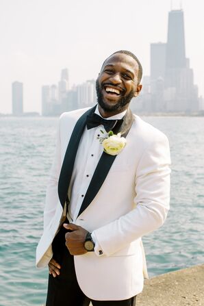 Groom Laughing Beside Lake Michigan in Chicago