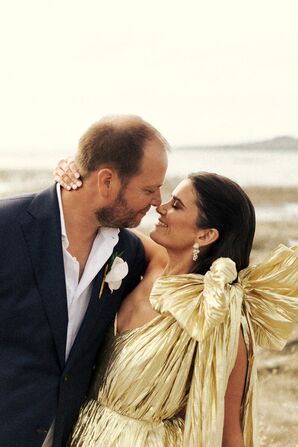 Groom in Casual Suit and Bride in Metallic Gold, One-Shoulder Dress on  Rocky Ledge of Beach