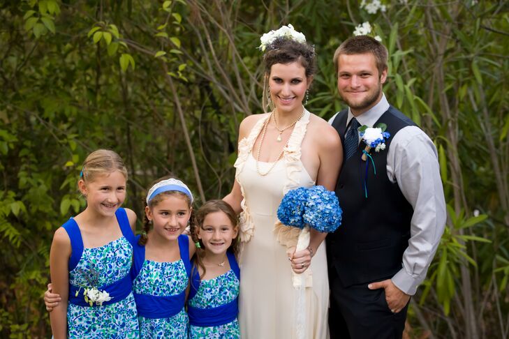 Aly and Christian stood with their three flower girls, who all wore blue floral dresses with bright blue straps that also weaved into a belt. The dresses matched nicely with the blue hydrangea bouquet that Aly walked down the aisle with. Each flower girl wore her hair in a different style.