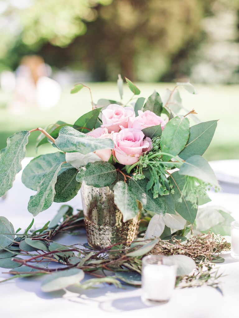 A lovely floral arrangement of pale pink roses and greenery.