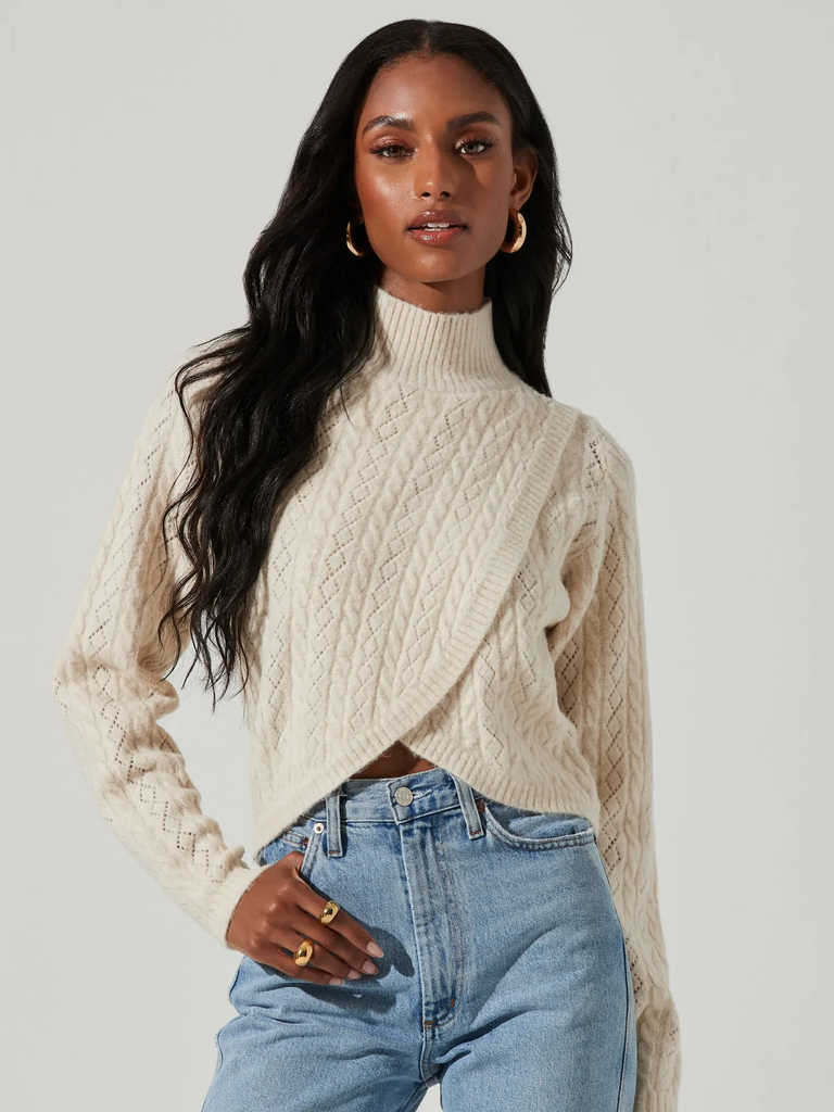 A model shows off this modern wrap cardigan in cream.