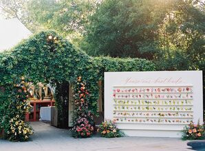 Colorful Escort Card Display With Live Flowers, Flower-Greenery Tunnel