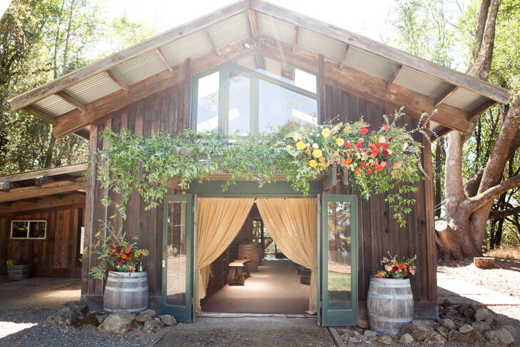 After the outdoor ceremony, guests picked up handcrafted beers and cocktails from the bar in this rustic structure—which sported an overhanging trellis that blossomed with all the right colors.
