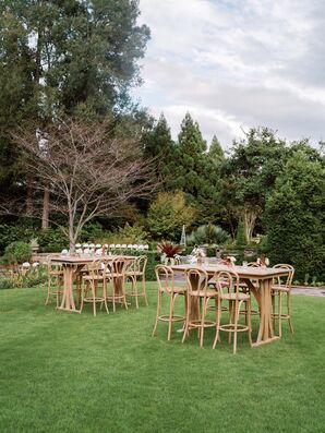 High Wood Cocktail Tables With Red Floral Accents at Garden Cocktail Hour