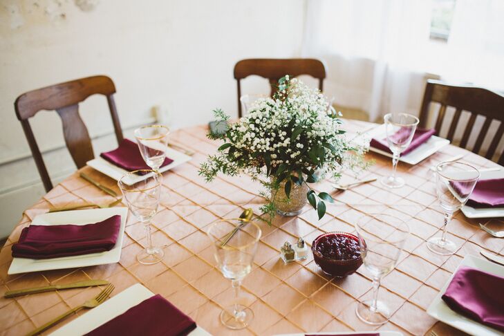 Morgan’s grandmother Doris Greene designed all the floral arrangements for the reception tables. To complement the vintage theme, she combined bundles of white gypsophila and Italian ruscus into crackled rose gold mirrored vases. Paired with gold flatware and gilded-rimmed glasses, the tablescapes took on an elegant old-world tone.
