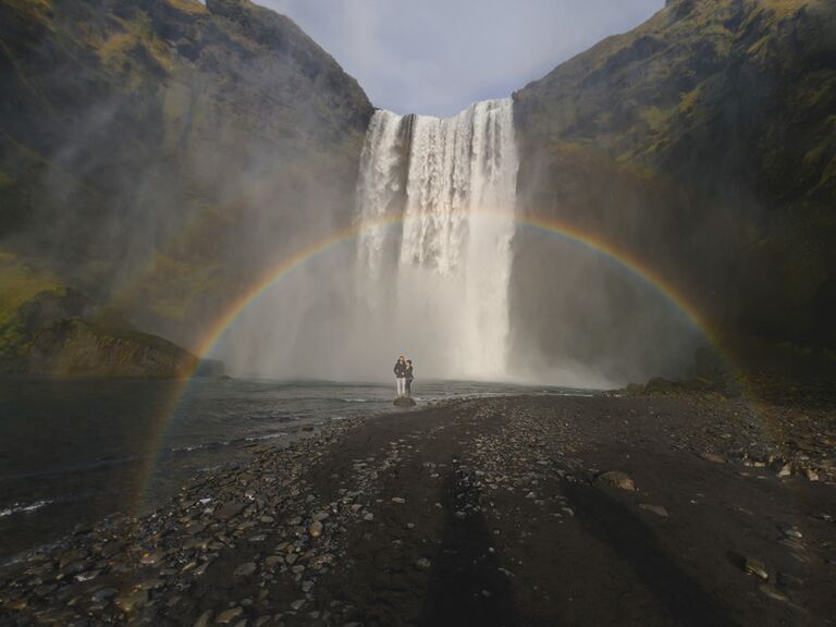 Western engagement photo idea in front of a waterfall. 