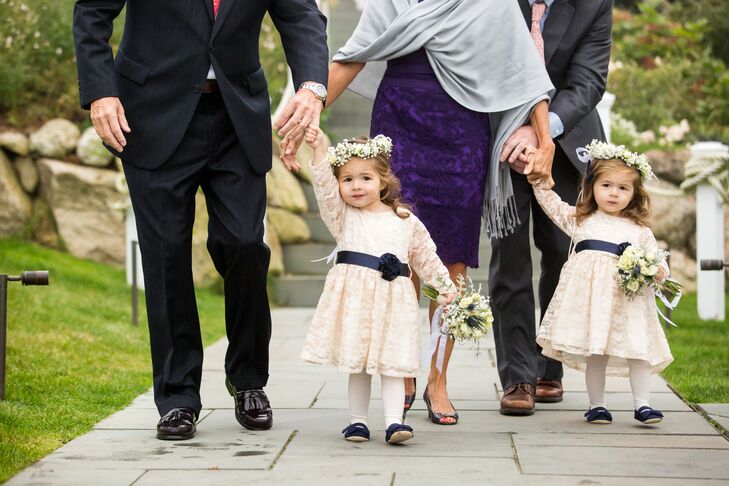 Instead of airy tulle dresses, Alexandria selected ivory lace dresses with long sleeves that the flower girls would easily be able to wear again.