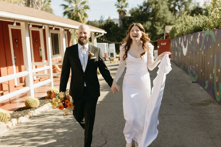 Groom in Black Suit, Bolo Tie and Bride in Modern Dress, Illusion Sleeves Walk With Colorful Bouquet