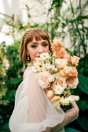 Bride With Flowing, Transluscent Sleeves, Pearl Headband, Earrings and Pink-and-White Bouquet