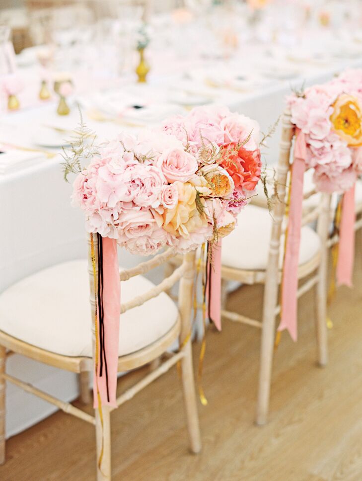 At the reception, Rebecca and Frans's chairs were accented with lush garden roses and peonies in shades of pink.