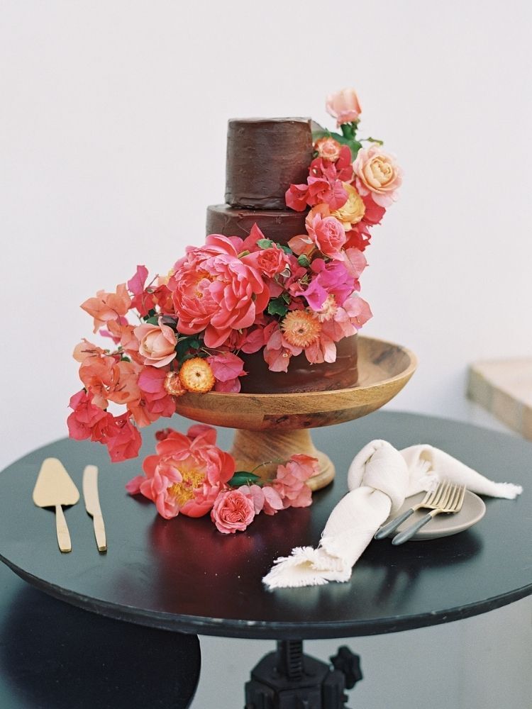 chocolate wedding cake decorated with bougainvillea