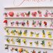 Colorful Escort Card Display With Live Flowers and Personalized Vases