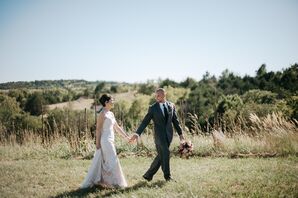 Bride and Groom Stroll Through Rustic Winery