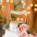 The small, two tiered cake was decorated with fresh flowers and featured a small Mr and Mrs bunting cake topper.
