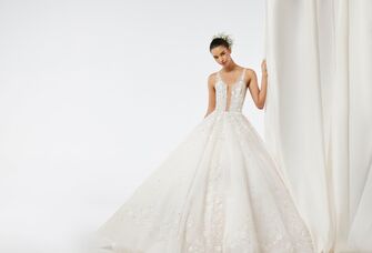 model wearing beaded ball gown with baby's breath flower crown in updo