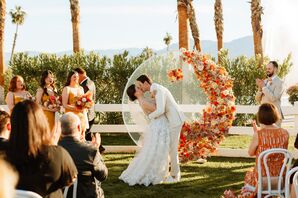 Couple Shares First Kiss With Floral Altar Structure at Bright Desert Ceremony