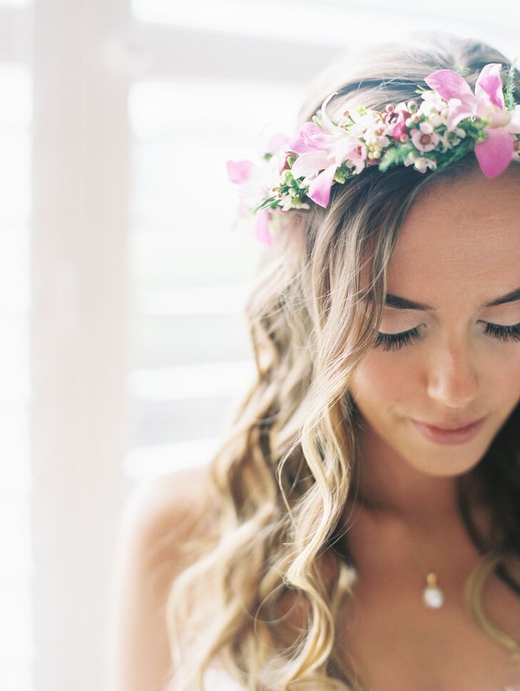 Laura wore a traditional Hawaiian bridal crown, called a haku, intertwined with greenery and pink blossoms.