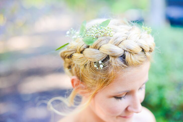 Talk about bohemian chic! Stephanie brought the couple's relaxed, natural style into her hairstyle. She wore a braided updo with wisps of baby’s breath and greenery set inside each twist. (We especially love how she matched the natural display with a green brooch along her waist.)