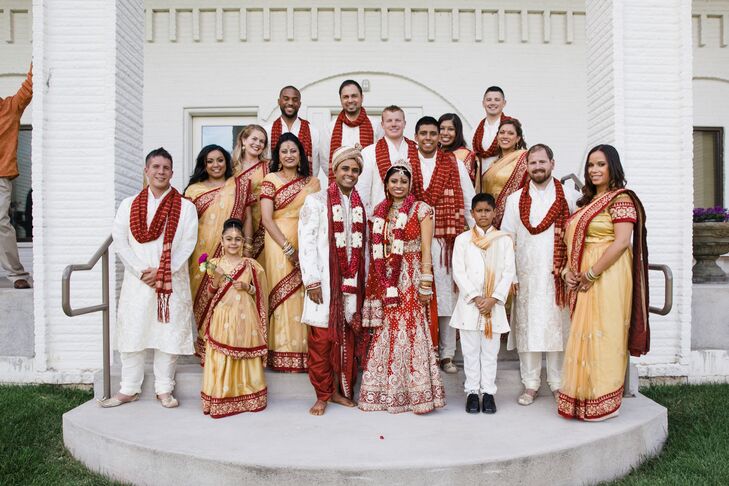 The eight groomsmen donned cream kurtas, which is traditional Indian attire for men. It was a light cream silk outfit with a red and gold scarf. They completed their look with traditional shoes embellished with silver and gold. The bridesmaids wore traditional red and gold saris to bring the whole look together. The wedding party attire came from Utsav Fashion in India.