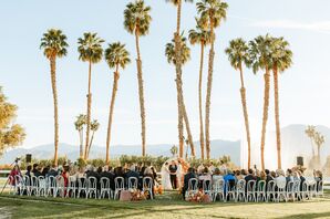 Bride and Groom Marrying Under Palm Trees and Floral Structure in Palm Desert