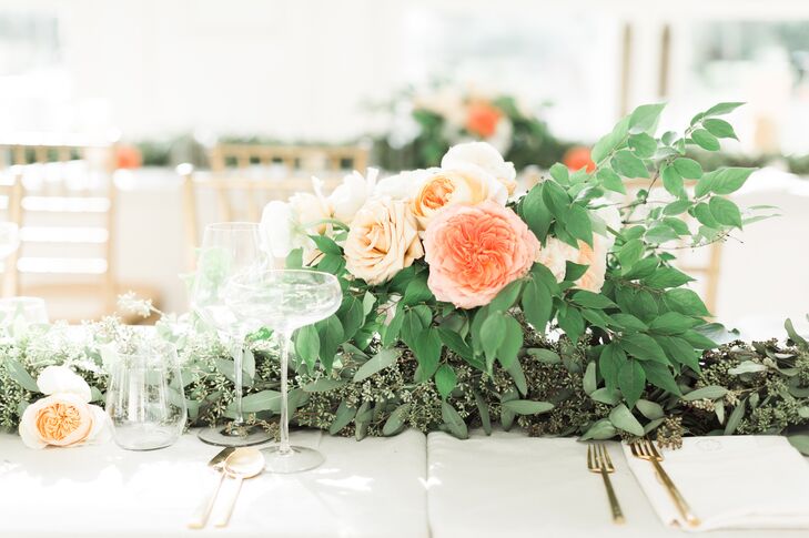 Lush, textured arrangements of eucalyptus and garden roses gave the tablescape an organic beauty.