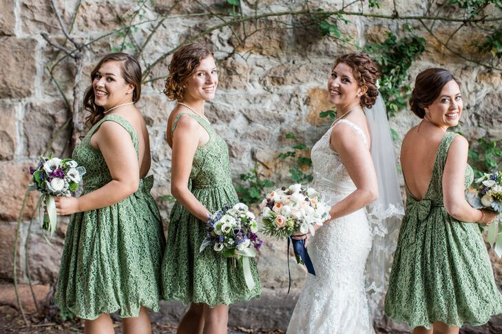 "The bridesmaids wore green knee-length dresses in a teacup style, accented in lace," Michelle says. "The dresses had a U-neckline and deep plunge back with a bow detail on the lower back, created by ModCloth."
