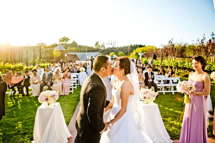 Joanne and Rainnier shared their first kiss outside at Leoness Cellars in Temecula, California. Joanna wore her hair in an updo hairstyle pinned with a white tulle veil.