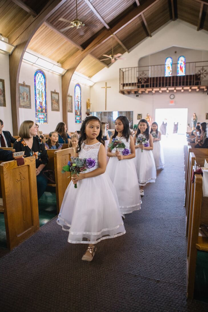 Elegant Flower Girls in White Dresses Carrying Bouquets