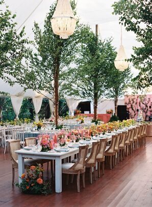 Long White Reception Table With Colorful Flowers, Chandeliers and Trees
