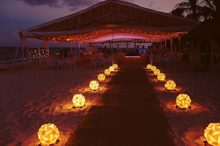 Spheres of lights on the sand led the way to Marta and Jose Luis's dance-party reception, which took place under a waterfront tent at Le Reve Hotel and Spa in Playa del Carmen, Mexico.