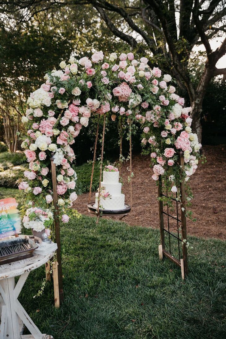 Cake on Swing Under Arch of Pink Roses