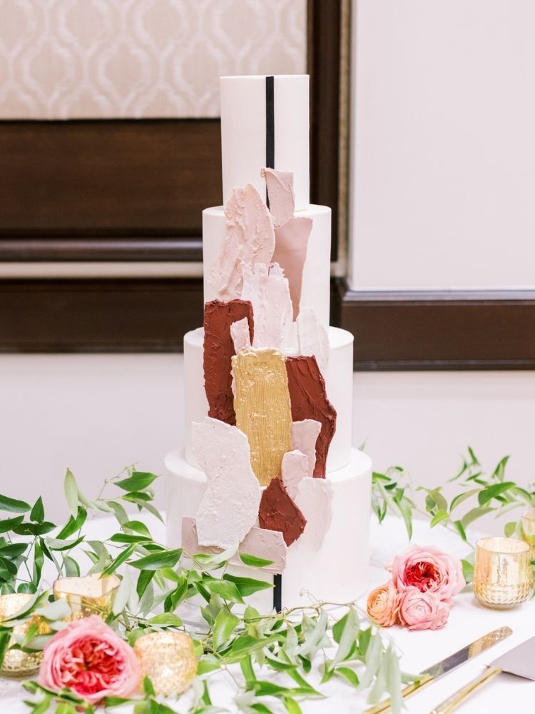 modern wedding cake with burgundy decorations 