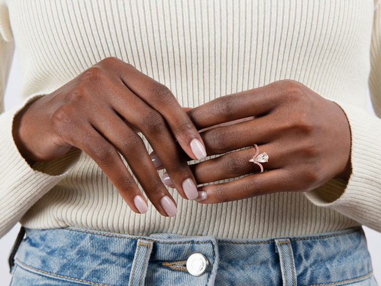 Pear diamond center on rose gold chevron band with pave diamonds