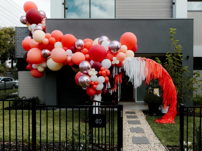 Orange balloon wedding reception installation