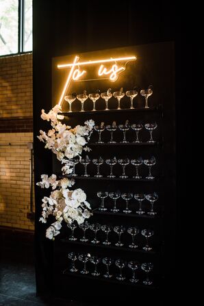 Glamorous Champagne Display with Flowers and Lighted Sign
