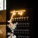 Glamorous Champagne Display with Flowers and Lighted Sign