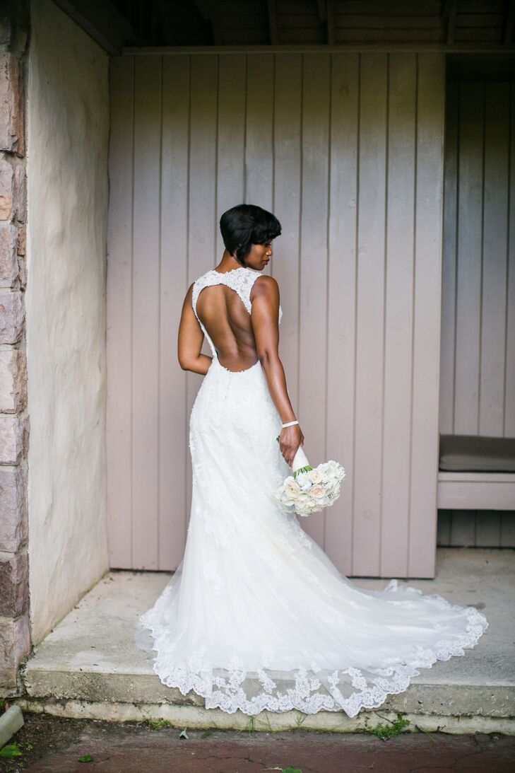 Dawnyelle wore a slim sheath-style Sophia Tolli dress that was adorned in tulle and crystal hand-beaded lace appliques. The sweetheart neckline had matching lace shoulder straps that continued into a dramatic plunging keyhole back. Her accessories included a thin crystal belt.