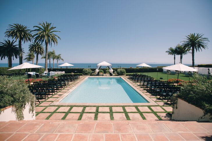 "We loved that our guests looked out over the Pacific Ocean as we said our vows," Brad says of the ceremony spot. Wooden folding chairs lined the perimeter of the pool, and a cabana-like structure served as the altar.